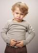 © Julia Zarubina - sad little boy holding his stomach, illness, cramps, health, color background, stomach-ache, abdominal, griping, bellyache, tummy-ache, gripes, portrait, ill, child, kid, baby, toddler, son, cry