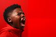 © alexkoral - black child boy screams on red isolated background