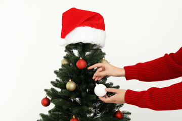 Wall Mural - A decorated Christmas tree with a red festive hat