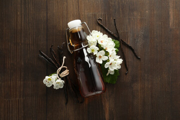 Poster - Vanilla extract in a bottle on a wooden background