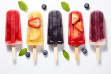Assorted Fruit and Berry Popsicles on White Background - Overhead View