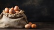 Fresh eggs in burlap bag on wooden table and blackboard background with copy space