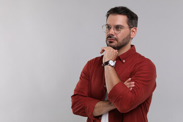 Poster - Portrait of man in stylish glasses on light grey background, space for text