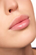 © Lustre Art Group  - Close up view of woman full pink with natural gloss lips, closed mouth. Beautiful plump lips. After treatment, moisturized lips.