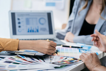 Creative team web designer planning application development for web mobile phone with customer breif and color code at office.