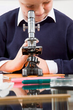 Schoolboy Looking In A Microscope
