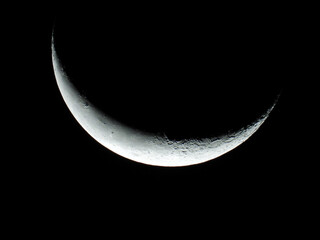 Wall Mural - moon in wanning crescent phase with dark sky in the background 