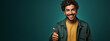 Young man smiling and making a positive gesture with his hand with thumbs up. Guy making like gesture with his hand dressed casually and on flat green background with copy space. Hispanic, Latino man.