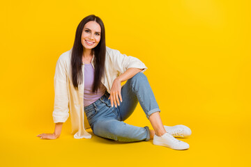 Sticker - Full length photo of lovely peaceful person sit floor chilling empty space isolated on yellow color background