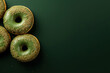 minimalistic green background with donuts, top view with empty copy space