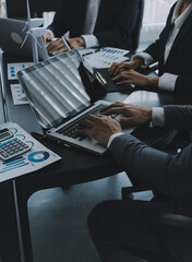 Close up of Business team analyzing income charts and graphs with modern laptop computer. Business analysis and strategy concept.