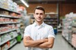 © vasyan_23 - a happy man seller consultant on the background of shelves with products in the store
