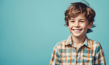 Excited Smiling Boy On Solid Color Background