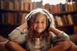 © vasyan_23 - a happy child girl in headphones on the background of shelves with books in the room