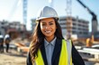 © vasyan_23 - Happy indian woman in an engineer hard hat at a construction site. Work process, construction of a house