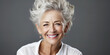 A beautiful adult business-like elderly healthy woman smiles with clean facial skin. The concept of advertising cosmetics for facial skin care and food additives.