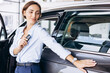 © Petro - Woman standing by her new car and holding car keys
