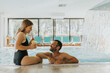 © BGStock72 - Young couple relaxing by the indoor swimming pool