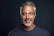 Adult man with smooth healthy face skin. Handsome aging mature man with gray hair and happy smiling touch face.