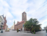 Fototapeta Nowy Jork - Toruń's Gothic town hall with cloudy sky in Poland