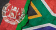 Afghanistan and South Africa flags, concrete wall texture with cracks, grunge background, military conflict concept