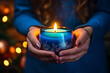 © Peffy's Photography - Womens hands holding a christmas candle