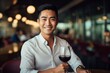 © vasyan_23 - happy modern asian man with a glass of expensive wine on the background of a fancy restaurant and bar