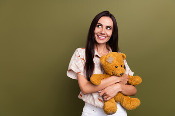 Sticker - Photo of young girlish person hispanic lady holding fluffy teddy bear gift looking dreamy empty space isolated on khaki color background