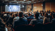 © Synaptic Studio - Rear view of people in audience at a business event in a conference hall