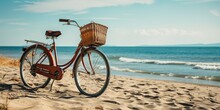 A Bicycle Parked On The Beach With A Basket On The Front.