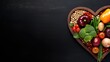 A heart shaped wooden plate filled with assorted fruits and vegetables, vegan January challenge.
