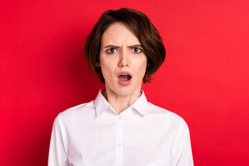 Poster - Photo of unhappy shocked upset young woman fake news reaction dislike isolated on red color background