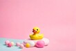 Creative layout with rubber duck and pink round on pastel background. Conceptual pop.