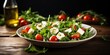 Fresh salad with green leaves mix, cherry tomatoes and cheese on a white plate with olive oil on a white background with copy space. Healthy dieting food.