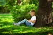 © BillionPhotos.com - School girl listening book in park. Concept of distance learning.