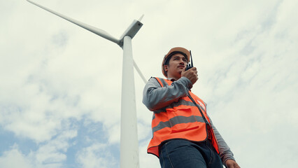 Sticker - Engineer working on a wind turbine with the sky background. Progressive ideal for the future production of renewable, sustainable energy. Energy generation from wind turbine.