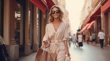 Attractive Blonde Woman With Shopping Bags Walking On A City Street.