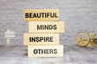 Beautiful Minds inspire others. Yellow piece of paper with text.