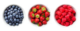 Fototapeta  - Top view of blueberries, strawberries and raspberries in bowls over isolated transparent background
