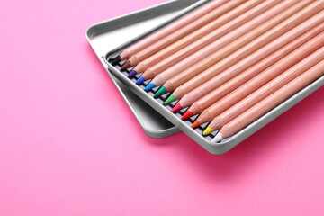 Poster - Box with many colorful pastel pencils on pink background, closeup and space for text. Drawing supplies