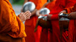 Buddhist monk holding alms bowl waitting for buddhism make merit by offering food and water at morning