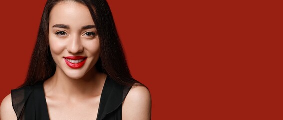 Canvas Print - Beautiful young woman with bright lipstick on red background with space for text