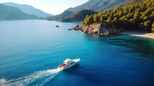 Aerial View Of Speed Boat On Blue Sea At Sunset In Summer. Motorboat On Sea Bay, Rocks In Clear Turquoise Water. Tropical Landscape With Yacht, Stones. Top View From Drone. Travel In Oludeniz, Turkey