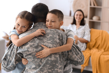 Wall Mural - Little children hugging their military father at home