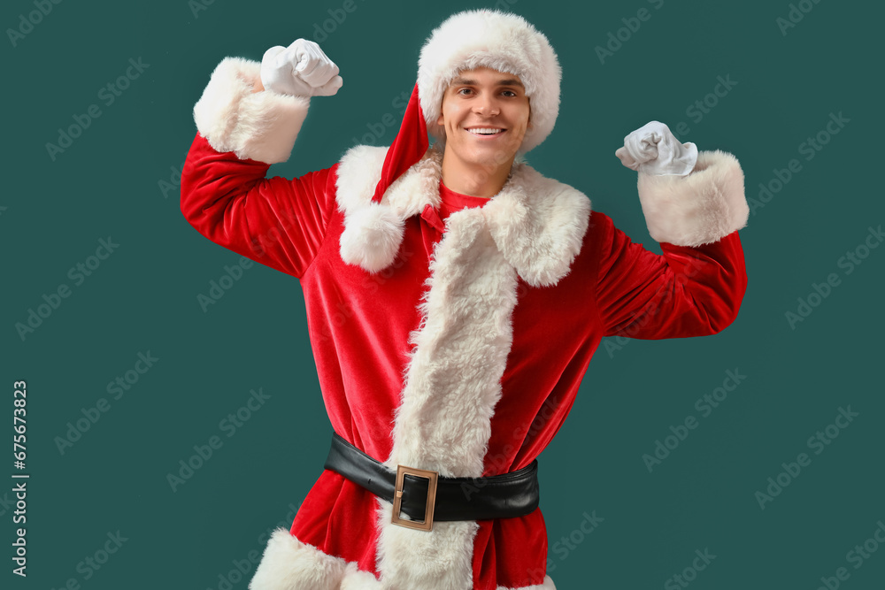 Santa Claus showing muscles on dark green background
