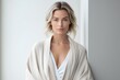 © yj - A sophisticated lady in a cashmere robe, on a minimalistic simple bright background. generative AI