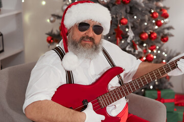 Poster - Cool Santa Claus playing guitar at home on Christmas eve