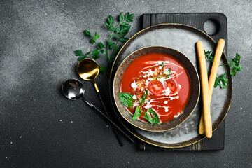 Wall Mural - Tomato soup with basil and cream. In a bowl. Healthy food concept. Close up.