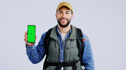 Poster - Happy man, backpack and phone green screen on mockup or hiking app against a studio background. Portrait of male person or hiker smile with bag and showing mobile smartphone display or travel tips