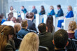 © Anton Gvozdikov - Businesspeople listening to board of directors on stage during conference meeting at export forum